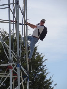 Denny Hoar of the NGS places an antenna on the top to collect GPS data overnight.