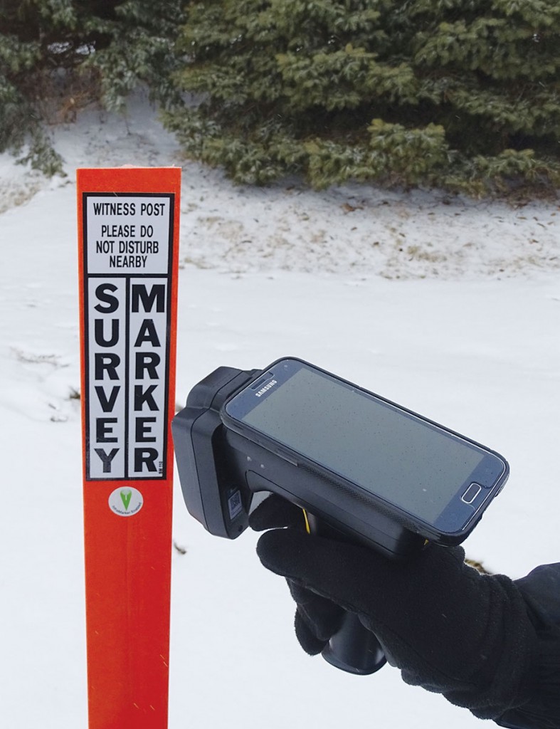 The application of RFID tags to survey markers can include tags on witness posts and tags embedded in the actual monuments. Here a hand-held UHF reader (with cradled smartphone) can both read and write to RFID tags in the field.