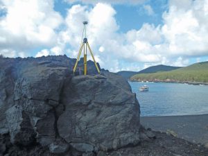 GPS equipment is set up over mark PAGAN 1 (PID AA5095) on the remote volcanic island of Pagan, Commonwealth of the Northern Mariana Islands, during a recent NGS survey aimed at determining the rotation of the Mariana tectonic plate for the purposes of defining MATRF2022.