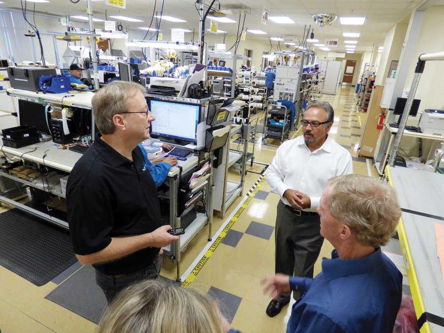 Executive VP of global operations Ray Vallejo (middle) and director of manufacturing Robert Kennedy (right) describe the lean manufacturing model for the Livermore factory. 