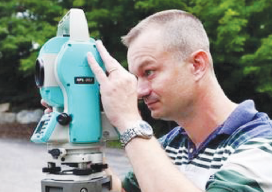 Ray Page surveys a plot of land on Route 4 in Rutland Town, Vermont. Photo: Anthony Edwards/ Rutland Herald