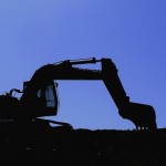 Digger silhouetted against a blue evening sky, crystal ball construction