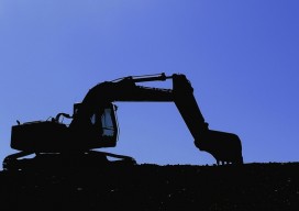 Digger silhouetted against a blue evening sky, crystal ball construction