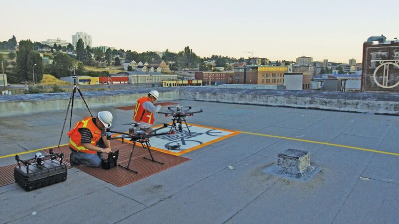 Remote pilots prepare UAS on the rooftop landing pad, or “Drone Port,” for test flights prior to a project application.