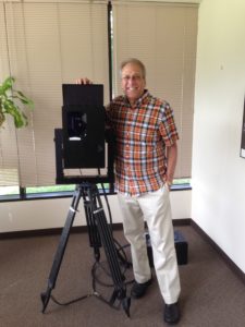 The author with original Cyrax 3D laser scanner. Note a large electronics box on the floor wired to the scanner. Not shown is a laptop that also needed to be connected to the scanner to operate it.