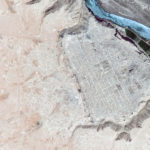 Satellite imagery of Dura Europos, Syria, an important archaeological site, shows the scale and extent of ISIS-led looting. The image (dark blue river) from April 2009 shows little impact compared to the image (light blue river) from April 2015 that shows pockmarked evidence of digging throughout the site.